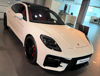 White sports car in a showroom - porche panamara gts